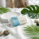 Fresh Aloe Cleansing Bar with tropical leaves and stones on white fabric