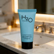 H2O Therapy Conditioning Shampoo tube on bathroom counter, janitorial supply store product